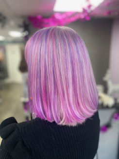 Creative pink and lilac vivid hair colour highlights created by the Balayage Bognor Regis specialists for a dimensional finish.