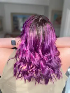 Vibrant purple and magenta vivid hair colour with soft waves, a bespoke look from our Bognor Regis hair experts.