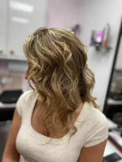 Multi-tonal blonde and honey highlights with voluminous curls, created by the hair experts at Bognor Regis.