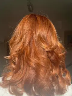 Rich copper red hair colouring with high-shine curls, a professional transformation by our Bognor Regis team.