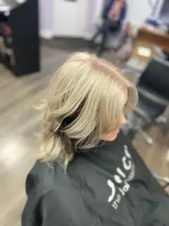 Platinum blonde hair with cool tones and soft face-framing layers, expertly coloured by our Bognor Regis team.